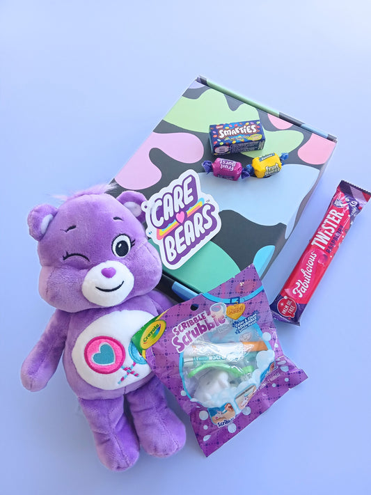 Gift box for kids, showing outside of multicoloured box, purple Care Bear plushie, Crayola Scribble Scrubbie Pet, Fabulicious Raspberry twister, Smarties box mini and two lollies.